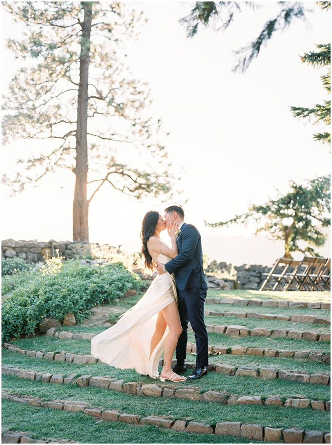 bride and groom kissing during sunset