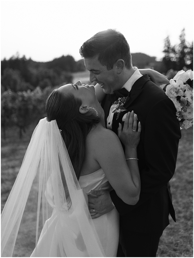 candid portrait of bride and groom laughing during sunset at oswego hills winery in Oregon