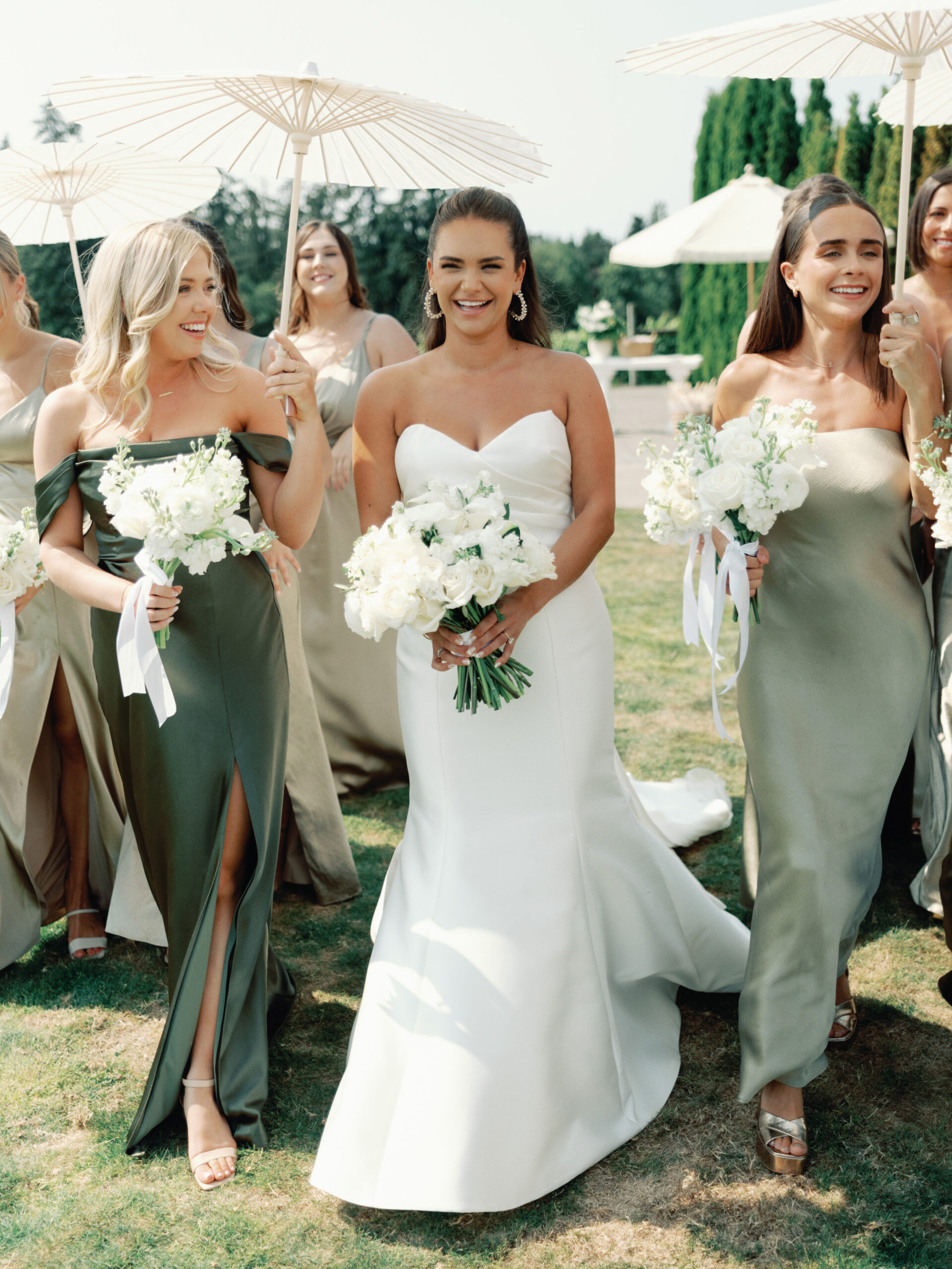 bridesmaids laughing and walking with parasols during wedding at oswego hills vineyard and winery near portland oregon